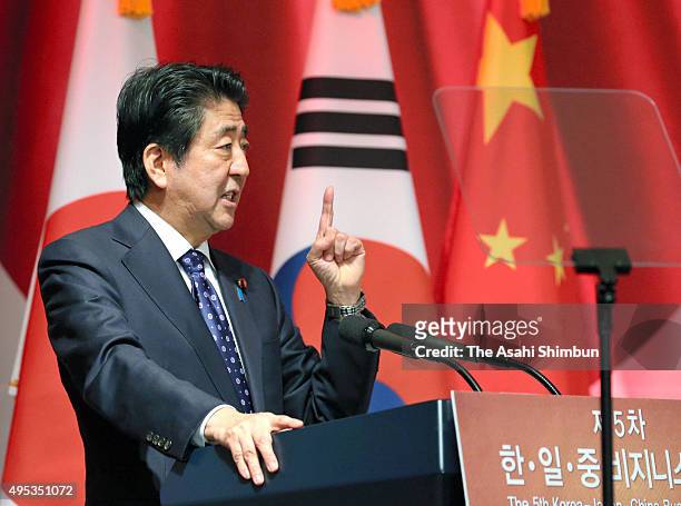Japanese Prime Minister Shinzo Abe addresses during a business summit on the sidelines of the trilateral summit between Japan, South Korea and China...