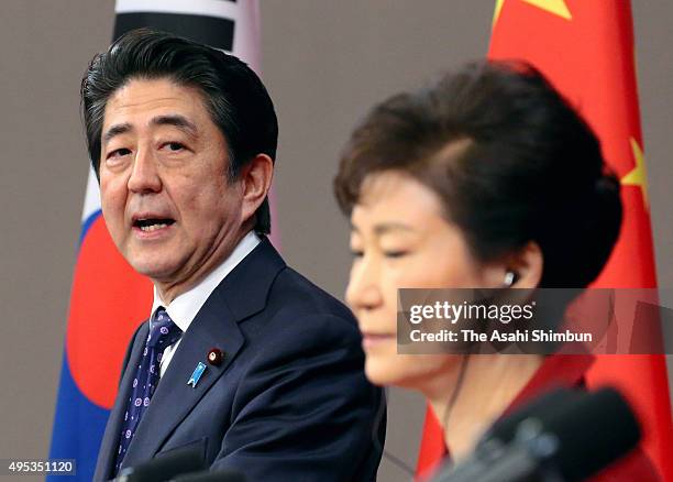 Japanese Prime Minister Shinzo Abe addresses while South Korean President Park Geun-hye during a joint press conference after the trilateral summit...