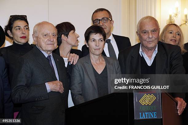 French writer Christine Angot poses between French writer Philippe Sollers and French businessman and prize donor Pierre Berge , after she received...