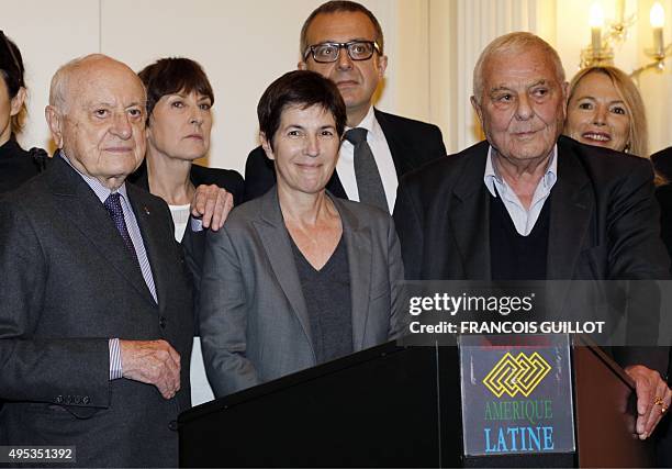 French writer Christine Angot poses between French writer Philippe Sollers and French businessman and prize donor Pierre Berge , after she received...