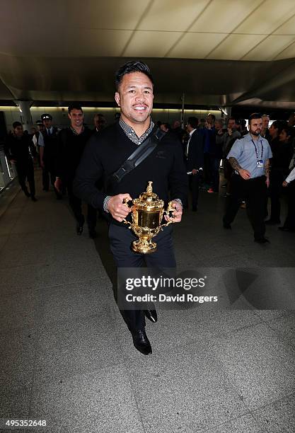 Keven Mealamu, of Rugby World Cup winners, the New Zealand All Blacks, carries the Webb Ellis Cup as the team arrive at Heathrow Airport at the start...