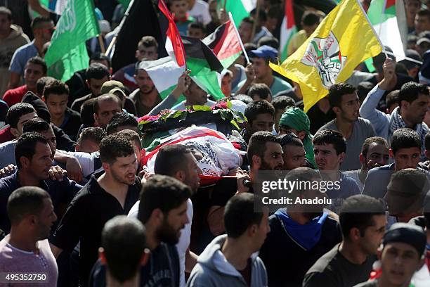 People carry the body of 23-years-old Palestinian Muhammad Shemasina, killed by Israeli soldiers on October, during his funeral ceremony in...