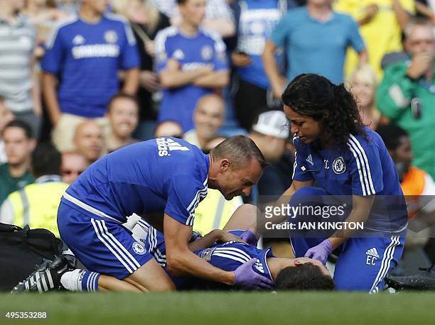 In a file picture taken on August 8, 2015 Chelsea doctor Eva Carneiro and head physio Jon Fearn treat Chelsea's Belgian midfielder Eden Hazard late...