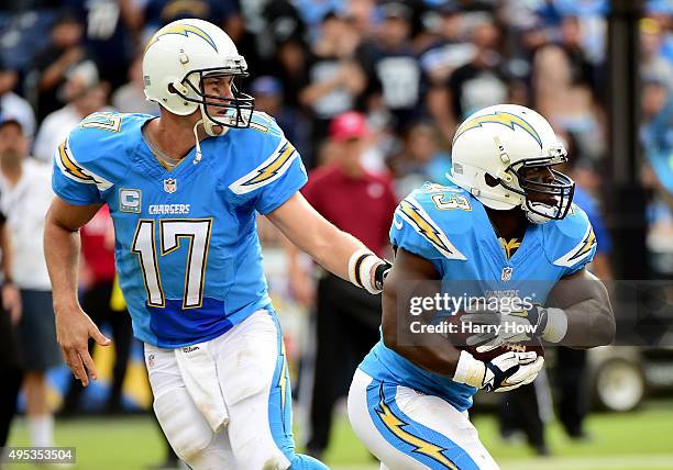 Philip Rivers of the San Diego Chargers hands off to Branden Oliver during the game against the Oakland Raiders at Qualcomm Stadium on October 25,...