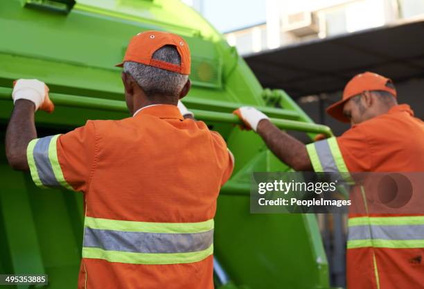 on the move to clean your city - garbage truck driving stock pictures, royalty-free photos & images