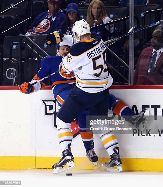 Rasmus Ristolainen of the Buffalo Sabres hits Mikhail Grabovski of the New York Islanders during the second period at the Barclays Center on November...