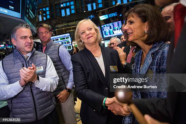 Meg Whitman , CEO of Hewlett Packard, shakes hands with people after the Hewlett Packard Enterprise stock is priced on the floor of the New York...