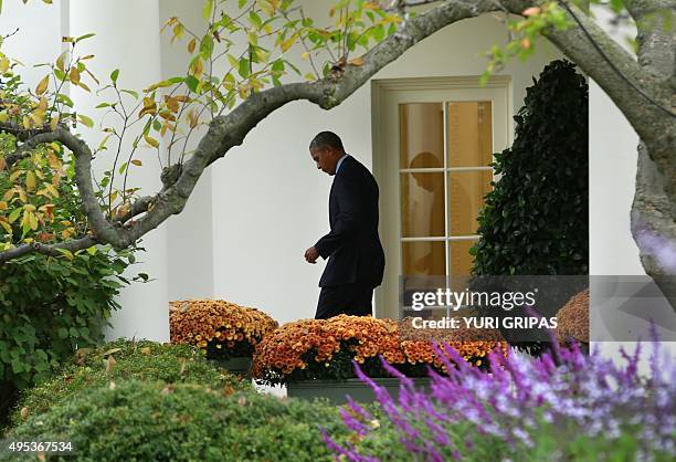 President Barack Obama walks out from the Oval Office of the White House to board Marine One in Washington as he departs for Newark, New Jersey on...