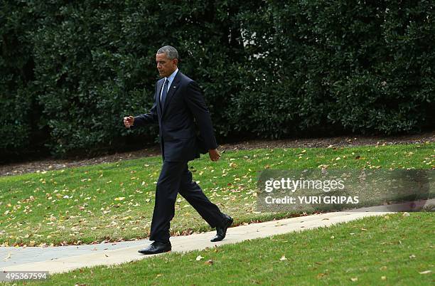 President Barack Obama walks from the Oval Office of the White House to board Marine One in Washington as he departs for Newark, New Jersey on...