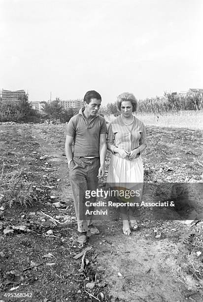 Italian actor Franco Citti and the actress Franca Pasut walking in a field in a scene from the film Accattone. 1961