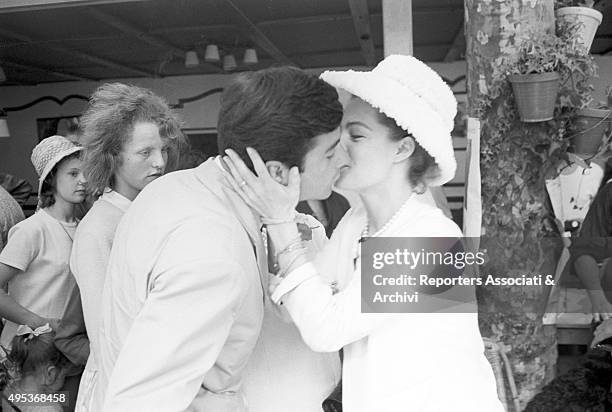 German-born French actress Romy Schneider kissing and French actor and director Jean-Claude Brialy at a lunch held for the 15th Cannes film festival....