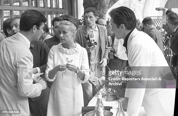 French singer, actress and director Jeanne Moreau and French actor and director Jean-Claude Brialy being photographed at a lunch held for the 15th...