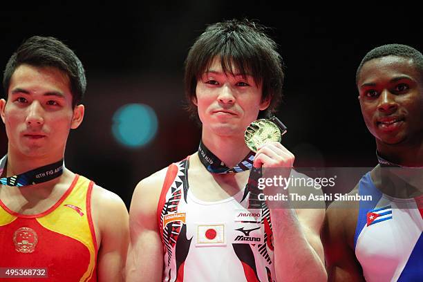 Bronze medalist Deng Shudi of China, gold medalist Kohei Uchimura of Japan and silver medalist Manrique Larduet of Cuba pose on the podium at the...