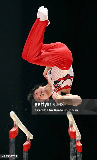 Kohei Uchimura of Japan competes in the Parallel Bars of the Men's All-Around during day eight of the 2015 World Artistic Gymnastics Championships at...