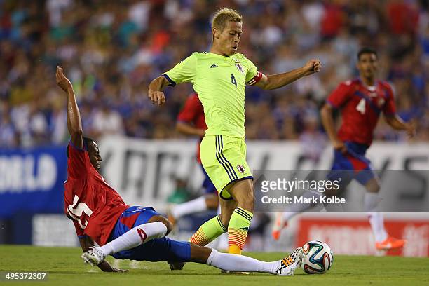 Keisuke Honda of Japan is tackled by Junior Diaz of Costa Rica during the International Friendly Match between Japan and Costa Rica at Raymond James...