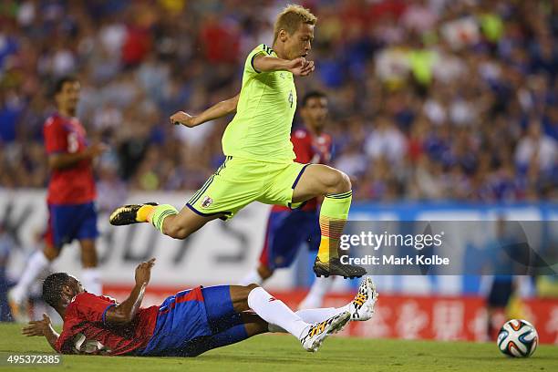 Keisuke Honda of Japan is tackled by Junior Diaz of Costa Rica during the International Friendly Match between Japan and Costa Rica at Raymond James...