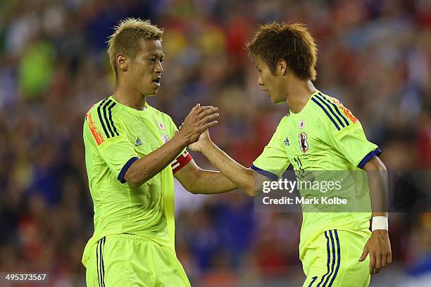 Keisuke Honda of Japan congratulates Yoichiro Kakitani of Japan after scoring a goal during the International Friendly Match between Japan and Costa...