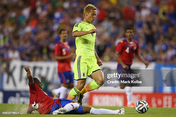 Keisuke Honda of Japan is tackled by Junior Diaz of Costa Rica during the International Friendly Match between Japan and Costa Rica at Raymond James...