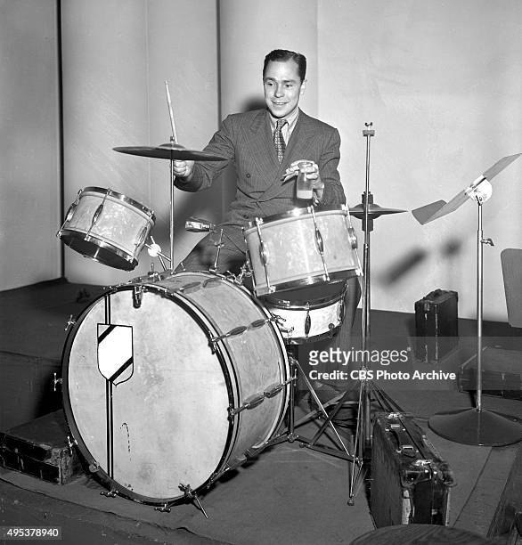 Songwriter Johnny Mercer playing drums. He performs regularly on The Camel Caravan radio program. January 17, 1939. New York, NY.