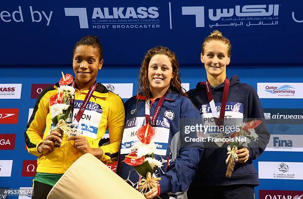 Alia Atkinson of Jamaica, Molly Hannis of USA and Leiston Picket of Australia celebrate on the podium after the Women's 100m Breaststroke final...