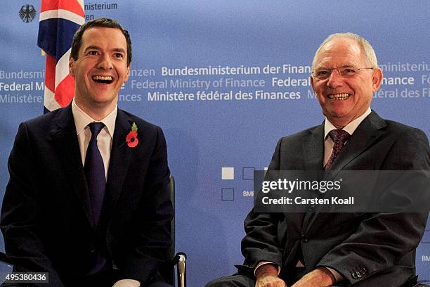 German Finance Minister Wolfgang Schaeuble and British Chancellor of the Exchequer George Osborne laughing to the press upon Osborne's arrival at the...