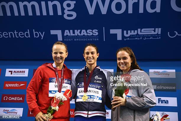 Melanie Wright of Australia, Anna Santamans of France and Natalie Coughlin of the USA celebrate on the podium after the Women's 50m Freestyle final...