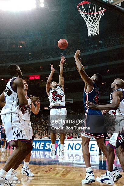 Damon Stoudamire of the Toronto Raptors shoots against the New Jersey Nets on November 3, 1995 at the Toronto SkyDome on November 3, 1995 in Toronto,...