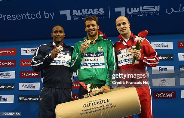 Giles Smith of the USA, Chad Le Clos of South Africa and Ivan Lender of Serbia celebrates on the podium after Men's 50m Butterfly final during day...