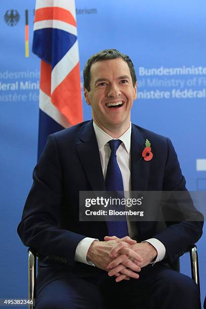 George Osborne, U.K. Chancellor of the exchequer, laughs while speaking with Wolfgang Schauble, Germany's finance minister, not pictured, at the...