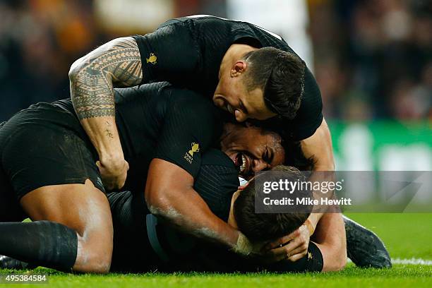 Beauden Barrett of New Zealand is congratulated by teammates Julian Savea and Sonny Bill Williams after scoring his team's third try during the 2015...