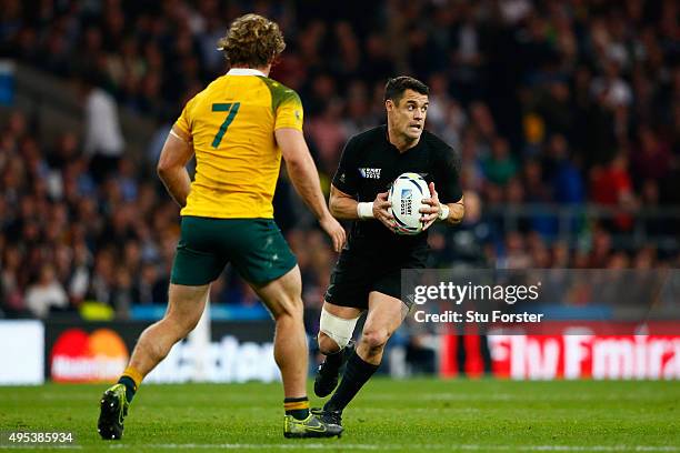 Dan Carter of New Zealand is challenged by Michael Hooper of Australia during the 2015 Rugby World Cup Final match between New Zealand and Australia...