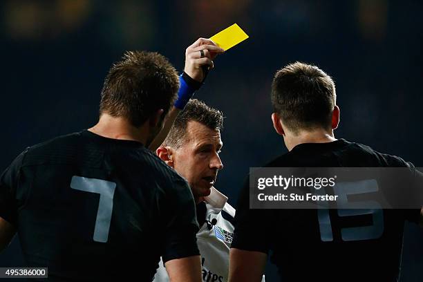 Referee Nigel Owens of Wales shows the yellow card to Ben Smith of New Zealand during the 2015 Rugby World Cup Final match between New Zealand and...