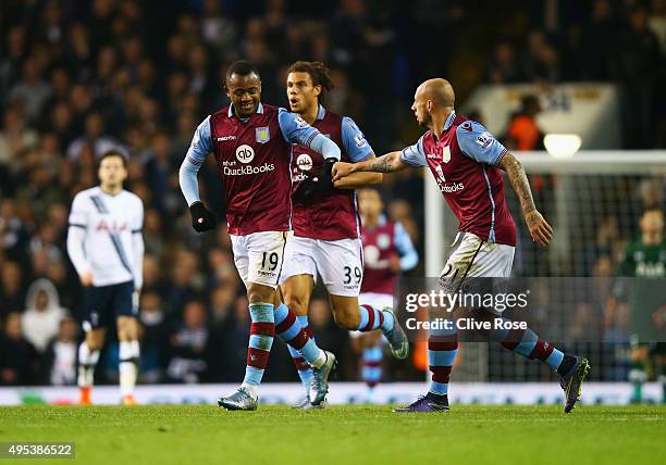 Jordan Ayew of Aston Villa celebrates with Alan Hutton as he scores their first goal during the Barclays Premier League match between Tottenham...