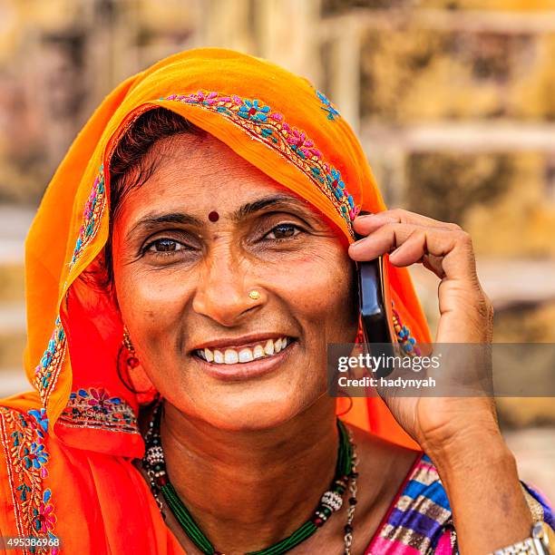 indian woman using mobile phone, village near jaipur, india - stepwell india stock pictures, royalty-free photos & images