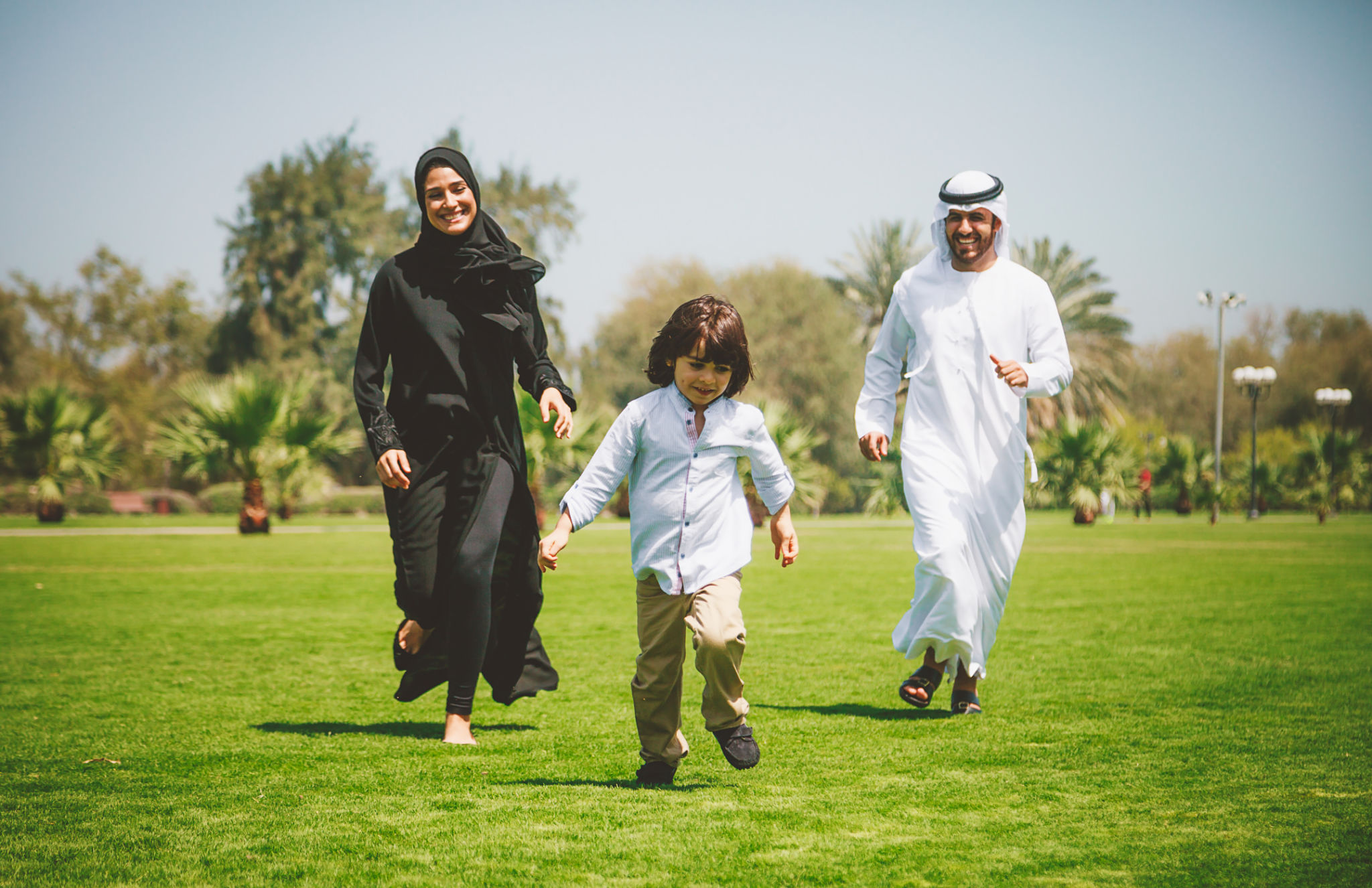 Happy Young Arabic family having fun outdoors at sunny day Happy Young Arabic family having fun outdoors at sunny day