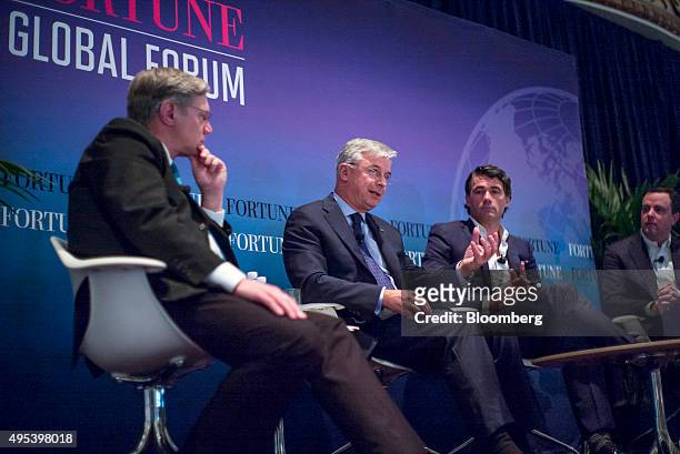 Hubert Joly, chairman and chief executive officer of Best Buy Co. Inc., second left, speaks as Gavin Patterson, chief executive officer of BT Group...