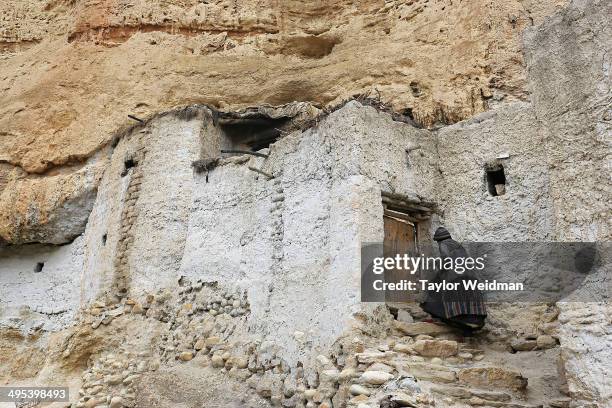 Pema Dolma returns to her cliffside home after receiving a rice donation from a neighbor on May 24, 2014 in Chosher, Nepal. Humans have lived in...