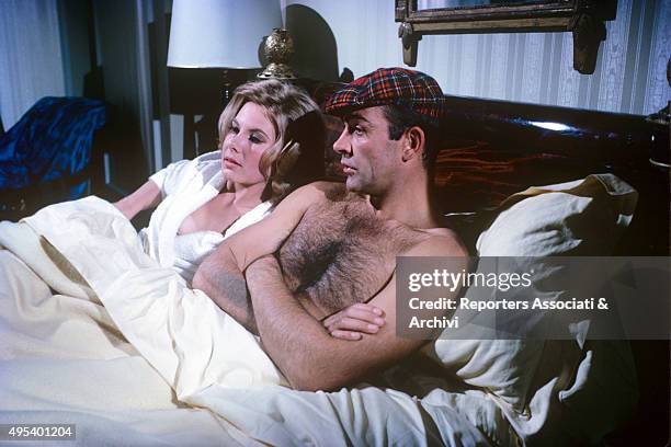 Scottish actor Sean Connery and Italian actress Luciana Paluzzi chatting in bed in the film Thunderball. 1965