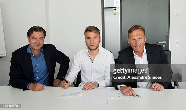 Sport director of Borussia Dormund Michael Zorc, Ciro Immobile and CEO of Borussia Dortmund Hans-Joachim Watzke sign the new contract on June 2, 2014...