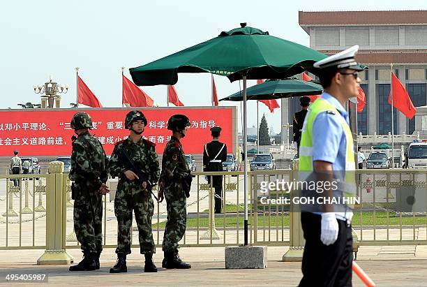 Armed Chinese police stand guard on Tiananmen Square in Beijing on June 3, 2014. A stepped-up police presence is visible on Beijing's streets, while...