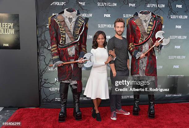 Actors Nicole Beharie and Tom Mison pose wtih headless horsemen at a special screening of Fox's "Sleepy Hollow" at Hollywood Forever on June 2, 2014...