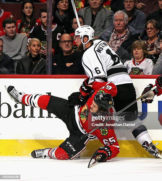 Andrew Shaw of the Chicago Blackhawks is dumped to the ice by Jake Muzzin of the Los Angeles Kings at the United Center on November 2, 2015 in...