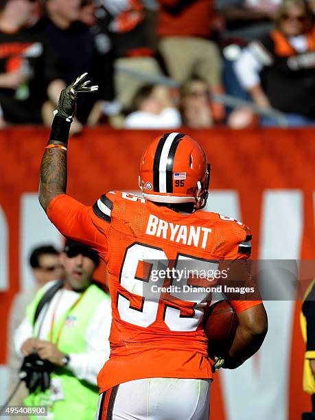 Defensive end Armonty Bryant of the Cleveland Browns celebrates a fumble recovery down the field during a game against the Arizona Cardinals on...
