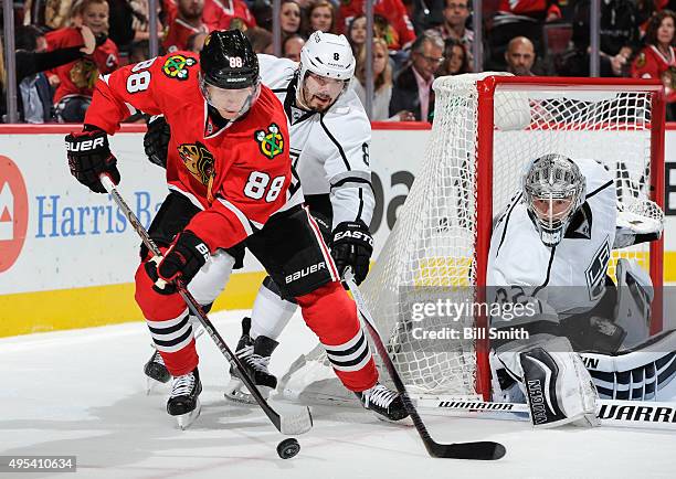 Patrick Kane of the Chicago Blackhawks and Drew Doughty of the Los Angeles Kings chase the puck next to goalie Jonathan Quick in the second period of...