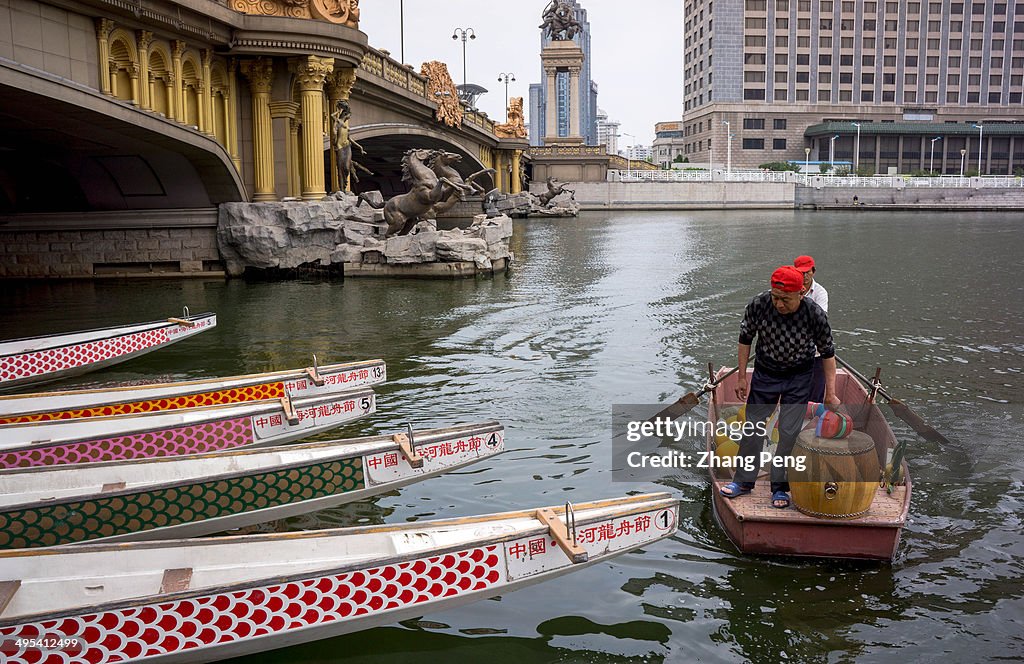 After the dragon boat race, workers collect and keep the...