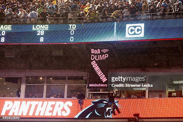 Protesters hang from the railings during the Carolina Panthers versus Indianapolis Colts Monday Night Football game at Bank of America Stadium on...