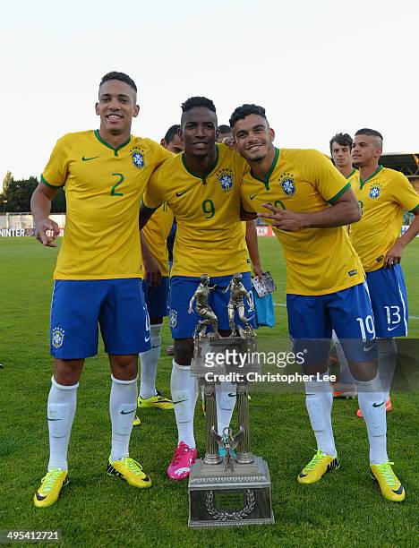 Gilberto, Thalles and Mosquito of Brazil celebrate their victory with the trophy during the Final of the Toulon Tournament between France and Brazil...