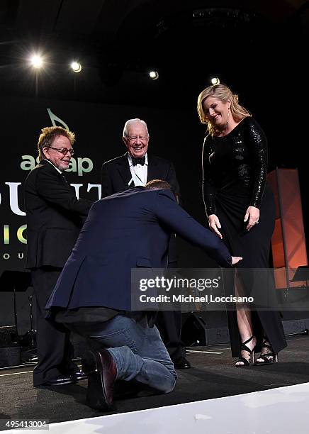 Justin Timberlake, ASCAP President and Chairman of the Board Paul Williams, and President Jimmy Carter present Trisha Yearwood with the Voice of...