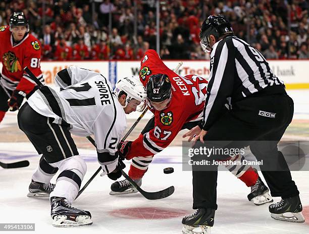 Linesman Andy McElman drops the puck during a face-off between Nick Shore of the Los Angeles Kings and Tanner Kero of the Chicago Blackhawks at the...