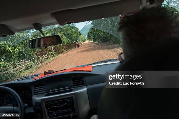 Senior Golden West staff drive towards their explosives testing range on June 3, 2014 in Kampong Chhnang, Cambodia. Three decades of wars have left...